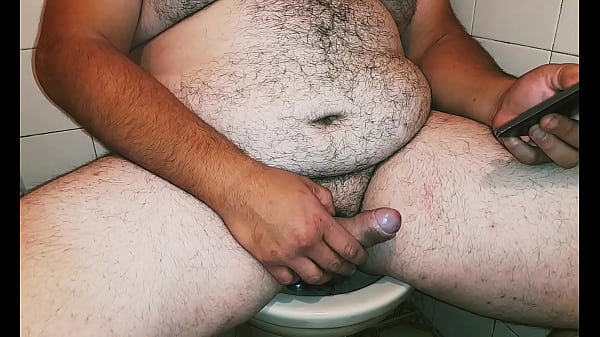 Fat male bear watches porn on his cell phone and masturbates